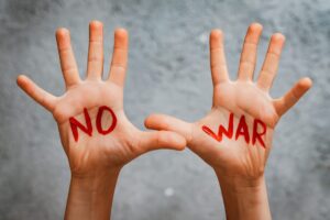 slogan peace without war is written child's hand red no war. concept of No war, stop war, peace